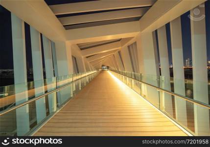 Interior design decoration of structure of twisted Bridge. Structure in Dubai, United Arab Emirates or UAE. Wooden floor in tunnel. Architecture background. Hall corridor in futuristic empty room.