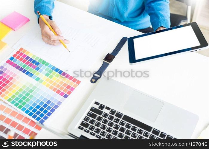 interior design or graphic designer renovation and technology concept - woman working with colour samples for selection. at workplace choosing colour swatches, closeup. Creative people 