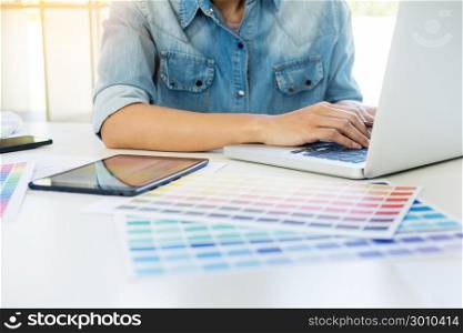 interior design or graphic designer renovation and technology concept - woman working with colour samples for selection.