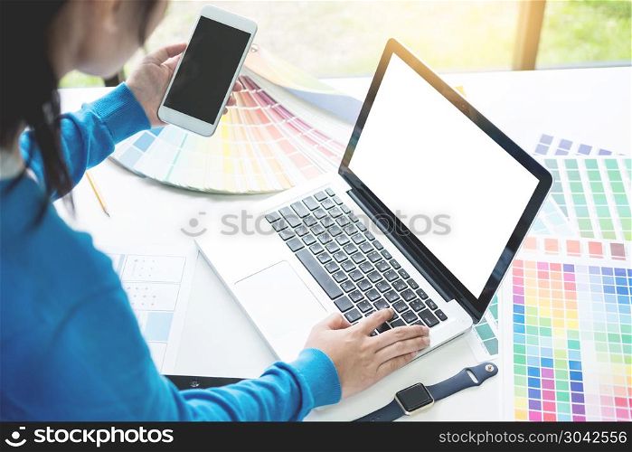interior design or graphic designer renovation and technology concept - woman working with colour samples for selection. at workplace choosing colour swatches, closeup. Creative people . interior design or graphic designer renovation and technology co