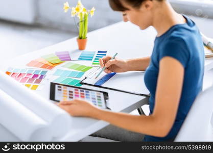 interior design, renovation and technology concept - woman working with color samples for selection