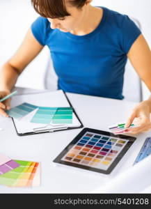 interior design, renovation and technology concept - woman working with color samples for selection