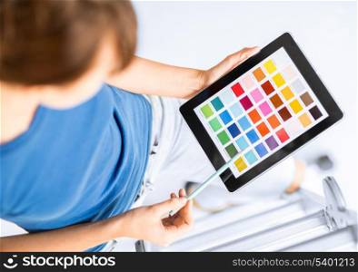 interior design, renovation and technology concept - woman working with color samples on tablet pc