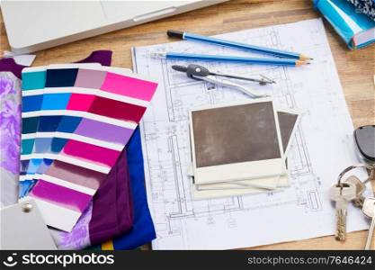 Interior designer&rsquo;s working table, an architectural plan of the house, color palette guide and fabric samples in lilac shades, copy space on instant empty photos. designer&rsquo;s working table