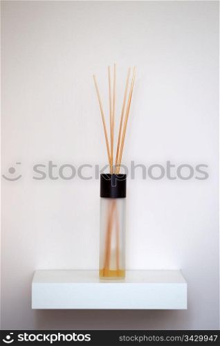 interior fragrance scent sticks. a white platter with interior fragrance scent sticks, this in a modern light creme and white room. A clean image usefull for the following subjects, Spa massage, modern contemporery interior design and other parfume like pictures