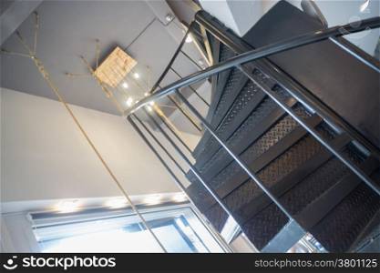 Interior metal dark spiral staircase, stock photo