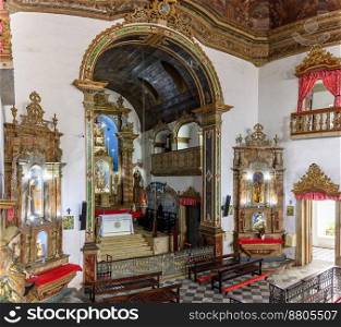Interior of a antique baroque church in Salvador, Bahia, richly decorated with gold-plated walls and altar. Interior of a antique baroque church in Brazil