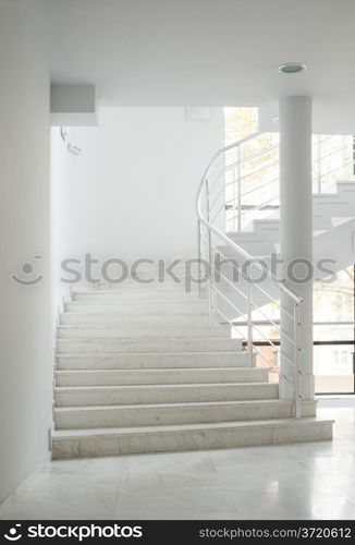 Interior of a building with white color walls. Flight of stairs