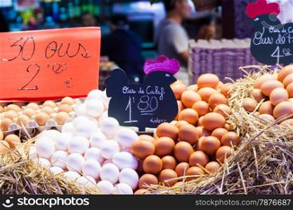 Interior of a busy food market, with detail of eggs group