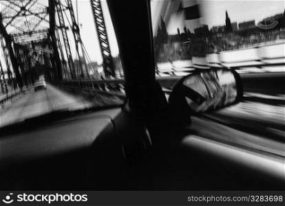 Interior of a car while it is traveling across bridge.