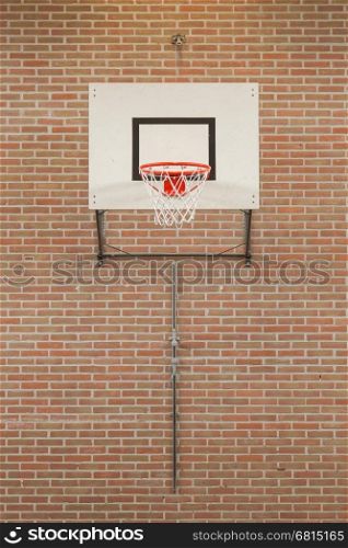 Interior of a gym at school, jumping high at the basket