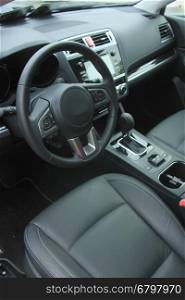 Interior of a modern luxury brand car, black leather and metal