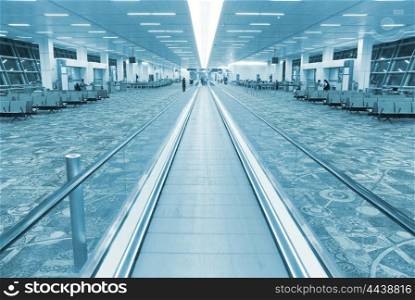 Interior of airport hall with the flat escalator. Blue colorized image