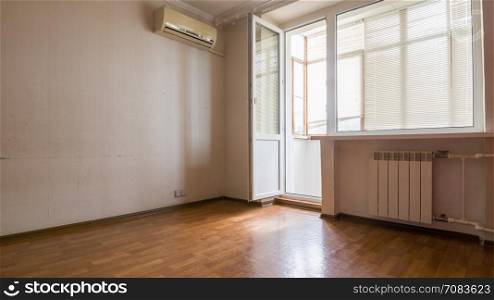 Interior of an empty room, a balcony and a view of the portion of the wall