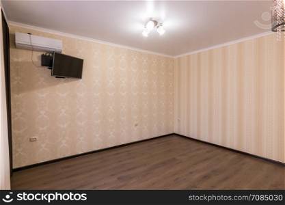 Interior of an empty room, the wall split system and TV
