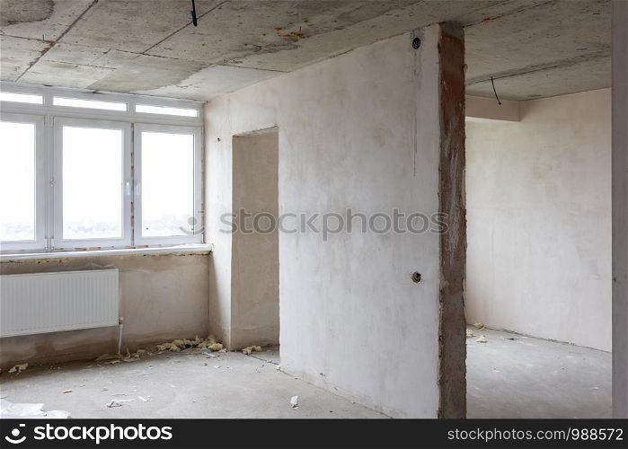 Interior of an empty room without repair in a new building