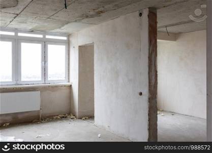 Interior of an empty room without repair in a new building