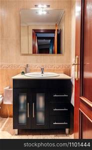 Interior of bathroom with washbasin cabinet and mirror