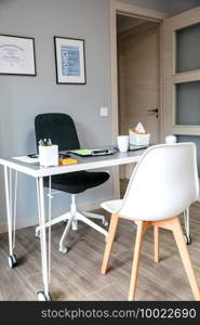 Interior of empty doctor’s office with table and cupboard