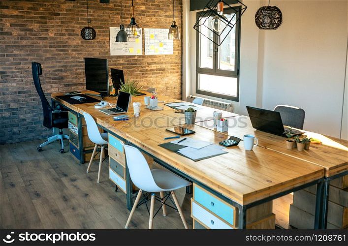 Interior of industrial style coworking office with various workplaces. Interior of industrial style coworking office