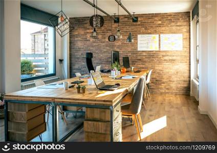 Interior of industrial style coworking office with various workplaces. Interior of industrial style coworking office