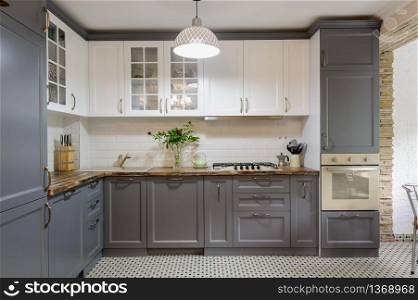 interior of modern luxury grey and white wooden kitchen. modern grey and white wooden kitchen interior