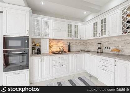 interior of modern white wooden kitchen in luxury home. modern white wooden kitchen interior