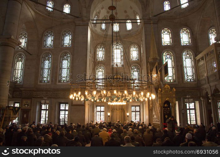 Interior of Ottoman time mosque with people in Istanbul
