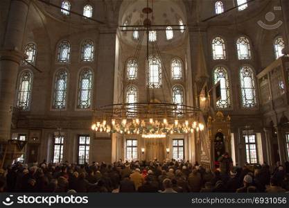 Interior of Ottoman time mosque with people in Istanbul