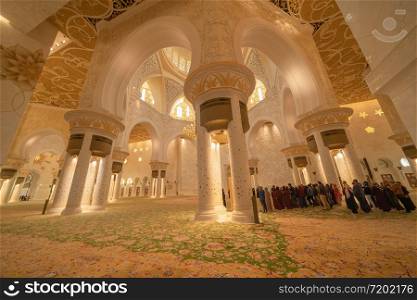 Interior of Sheikh Zayed Grand Mosque Center, Abu Dhabi. The largest mosque in United Arab Emirates or UAE. Muslim or Islamic white architecture building. Landmark tourist attraction.