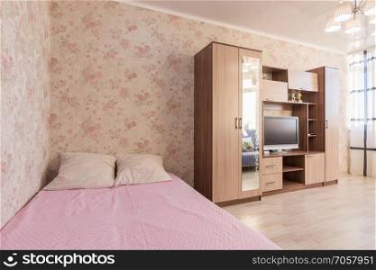 Interior of the hotel room, bed, wardrobes, TV