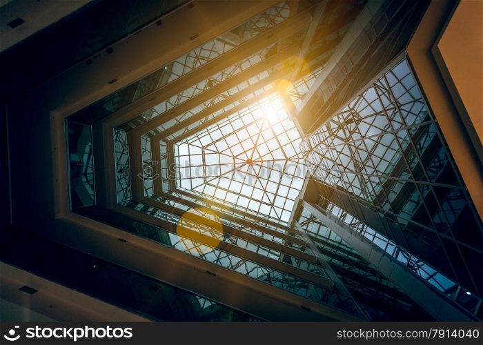 Interior photo of modern building atrium with shining sun