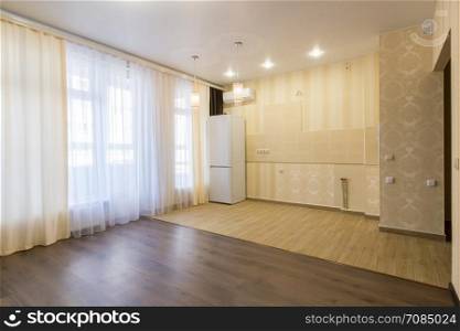 Interior renovated kitchen combined with a living room, unfurnished