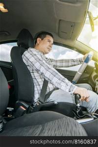Interior view of a young man driving a car, A happy man driving a car, Side view of a man driving a car, concept of man brand new car