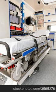 Interior view of an ambulance car with gurney in focus