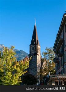 Interlaken, Switzerland - Evening light touch historic old bell tower Schlosskirche Interlaken Castle church with blue sky