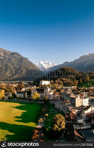 Interlaken, Switzerland - Evening scene aerial view cityscape vintage Swiss style buildings and mountain of Interlaken old town area, famous town for tourists