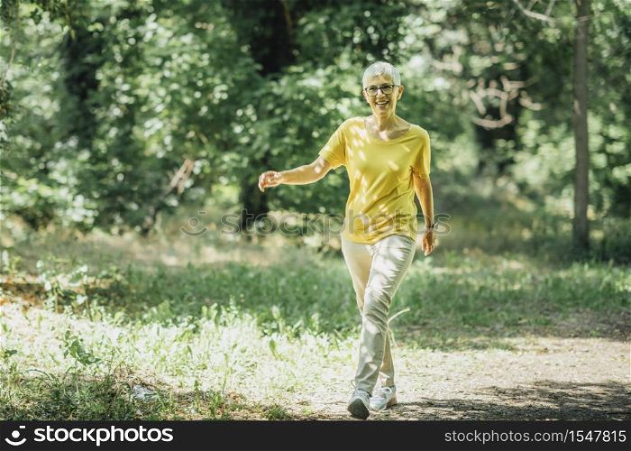 Intermittent walking workout, mature woman exercising, losing weight during menopause. Intermittent Walking Workout, Mature Woman Exercising