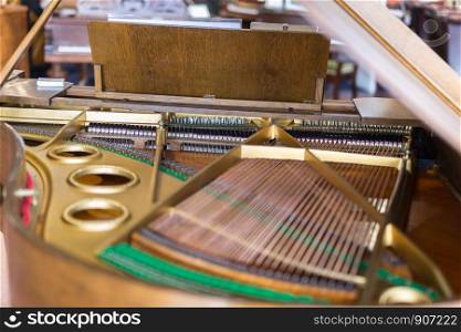 Internal Classic and Golden Piano Strings seen from above.. Internal Classic and Golden Piano Strings seen from above