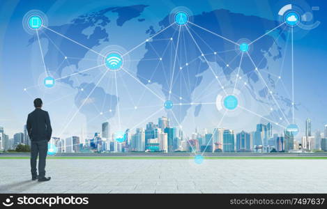 International business concept with businessman on city skyline background with network and map