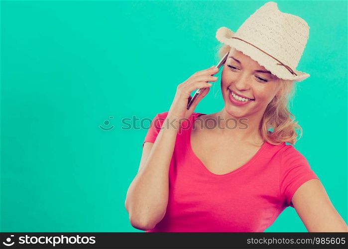 International calls, calling friends and family abroad, modern technology concept. Tourist woman with sun hat talking on phone. Tourist woman with sun hat talking on phone