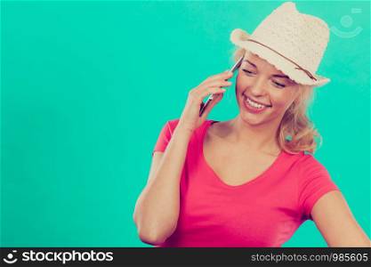 International calls, calling friends and family abroad, modern technology concept. Tourist woman with sun hat talking on phone. Tourist woman with sun hat talking on phone