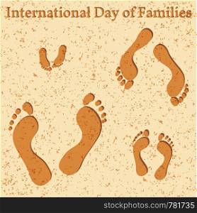 International Day of Families. Concept of a family of 4 people - father, mother, daughter, baby - their footprints on the beach. International Day of Families