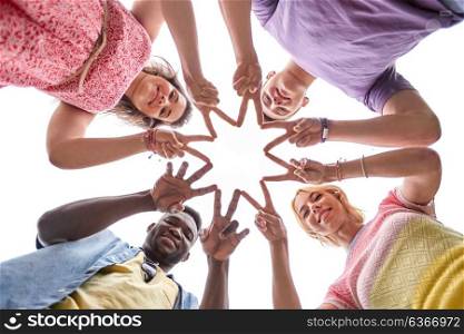 international friendship, unity and people concept - group of happy smiling friends outdoors showing peace hand sign standing in circle. group of happy friends showing peace hand sign