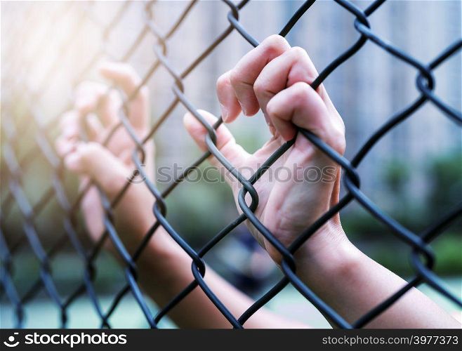 International Human Rights Day Concept, Women hand on chain-link fence. Depressed, trouble and solution