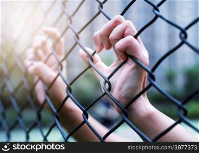 International Human Rights Day Concept, Women hand on chain-link fence. Depressed, trouble and solution