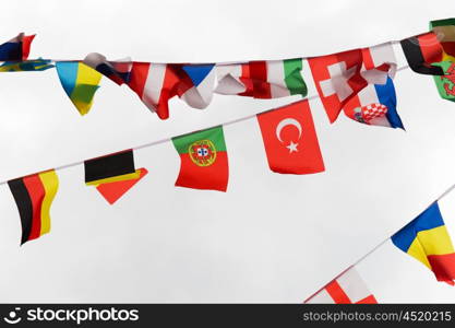 international symbolics and unity concept - close up of national flags garland decoration. close up of international flags garland decoration