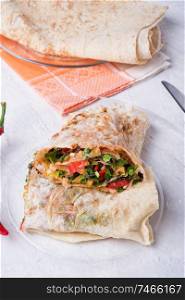 international vegetarian  shawarma sandwich roll. served at white table. arabian and caucaisian cuisine. Healthy fast food. 