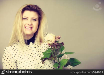 International women or mother day. Beautiful portrait of pretty woman blonde hair with white rose flower. Toned image. Pretty woman with white rose flower