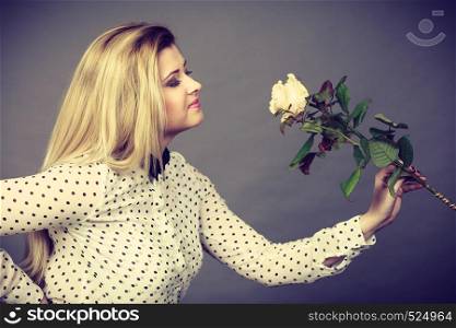International women or mother day. Beautiful portrait of pretty woman blonde hair with white rose flower. Dark day background. Pretty woman with white rose flower